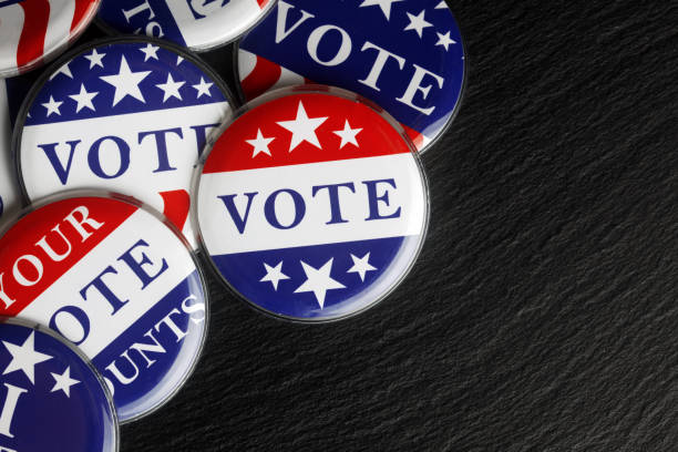 istock Red, white, and blue vote buttons background 1018521750