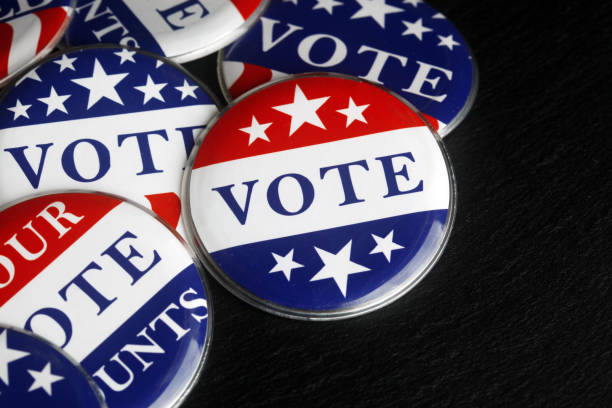 istock Red, white, and blue vote buttons background 1018521778