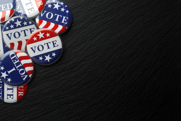 istock Red, white, and blue vote buttons background 1018521812