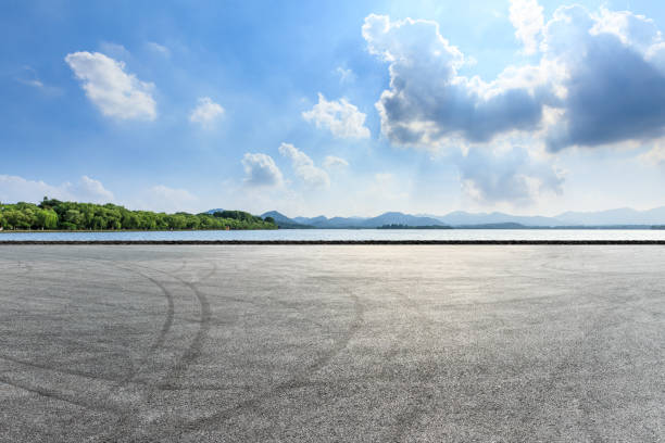 istock Asphalt square and mountain with lake on a sunny day 1018527414