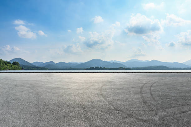 istock Asphalt square and mountain with lake on a sunny day 1018527488