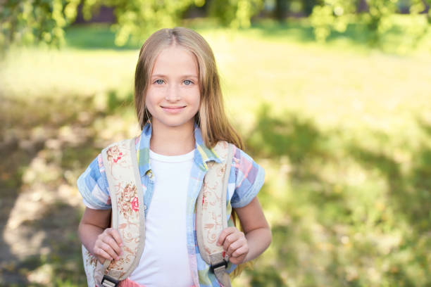 istock junior schoolchildren smile. casual textbooks. First grade. Study exam 1018540598