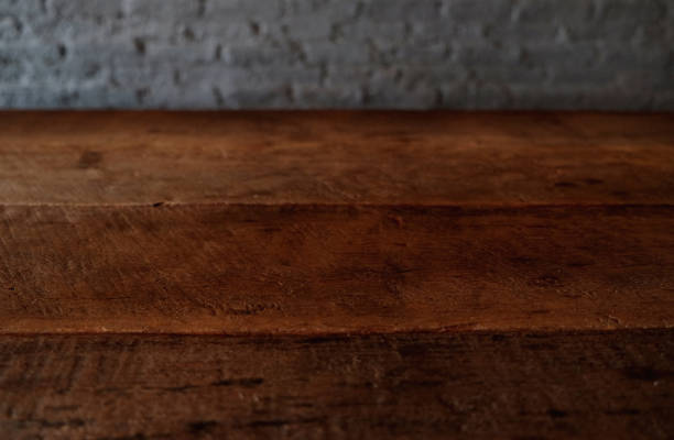 istock Empty top of wooden table or counter isolated on rustic brick Texture background. For product display 1018545790