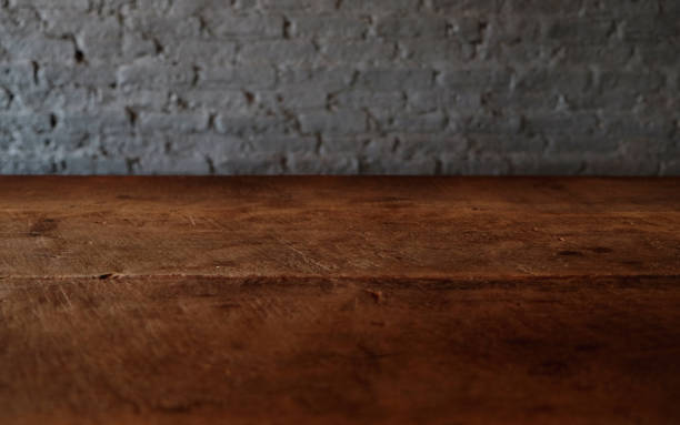 istock Empty top of wooden table or counter isolated on rustic brick Texture background. For product display 1018545798