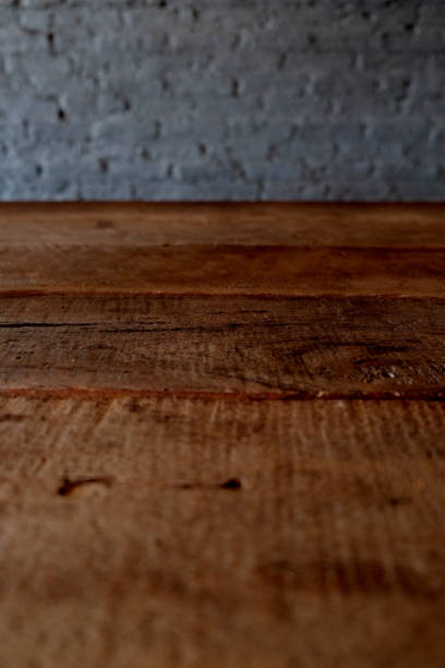 istock Empty top of wooden table or counter isolated on rustic brick Texture background. For product display 1018545800