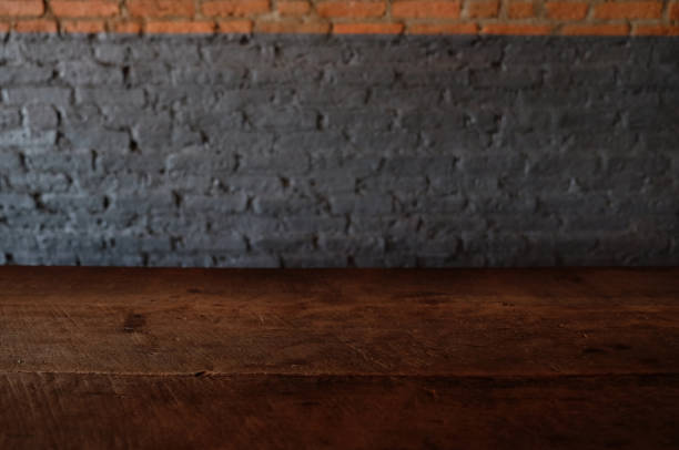 istock Empty top of wooden table or counter isolated on rustic brick Texture background. For product display 1018545804