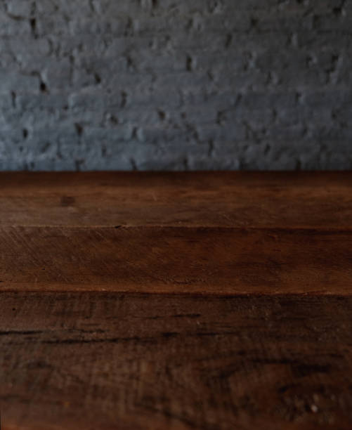 istock Empty top of wooden table or counter isolated on rustic brick Texture background. For product display 1018545806