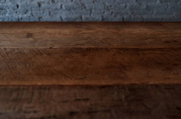 istock Empty top of wooden table or counter isolated on rustic brick Texture background. For product display 1018545810