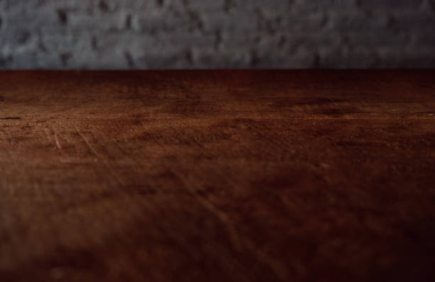 Empty top of wooden table or counter isolated on rustic brick Texture background. For product display