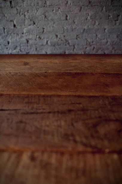 istock Empty top of wooden table or counter isolated on rustic brick Texture background. For product display 1018545846