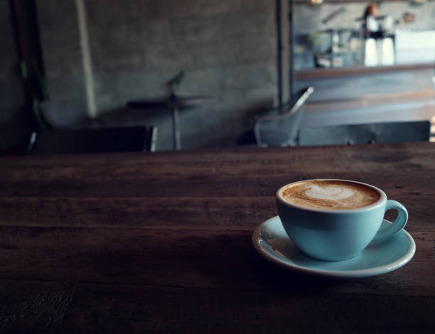 istock cup of coffee on table in cafe - vintage style effect picture 1018545868