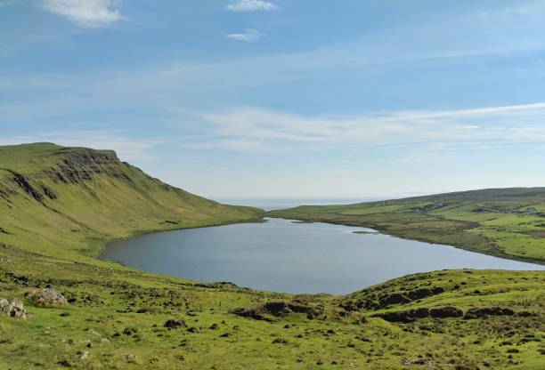 istock A big beautiful Lake on a mountain surrounded by green hills and cliffs under the bright blue sky. 1018560618