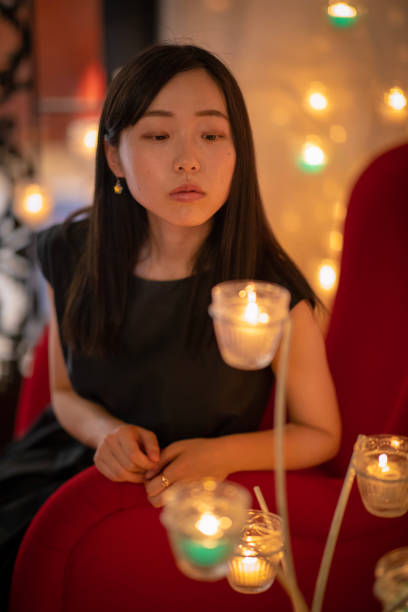 istock Young woman looking at candle lights at party 1018565784