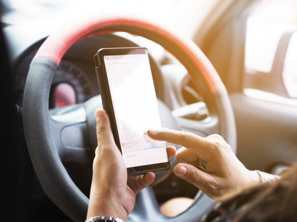 istock People in car playing smartphone 1018565970