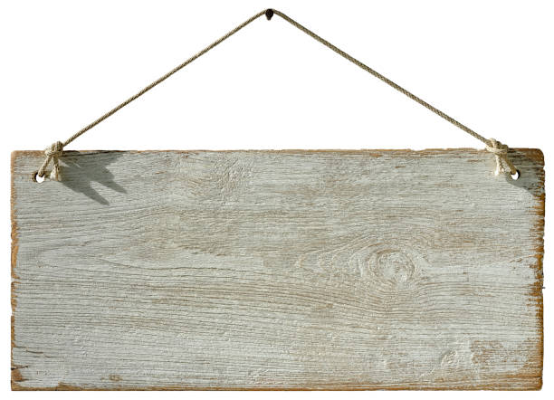 istock Old weathered worn white wooden board sign panel, hanging by old rope from a rusty nail, isolated on white, clipping path included. 1018578156