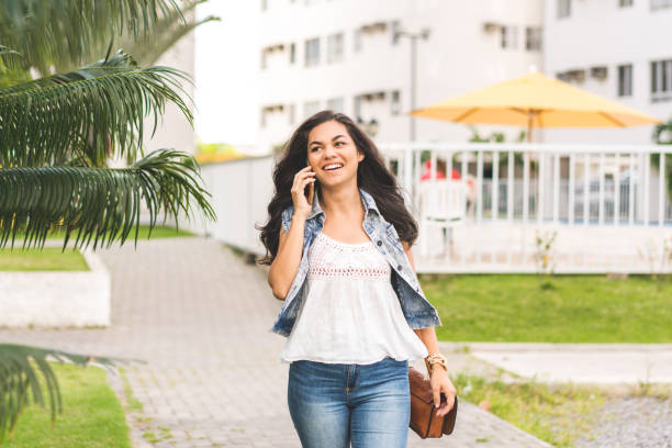istock Stylish young woman with smart phone 1018589210