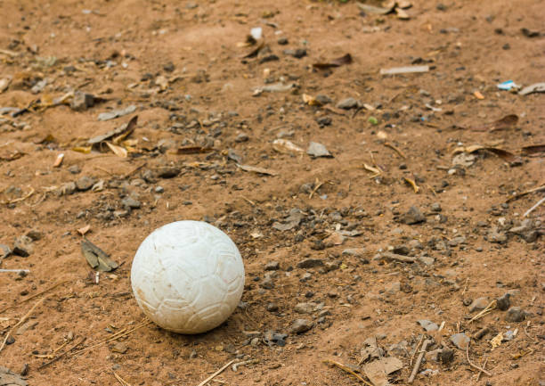 dirty  plastic soccer ball on ground