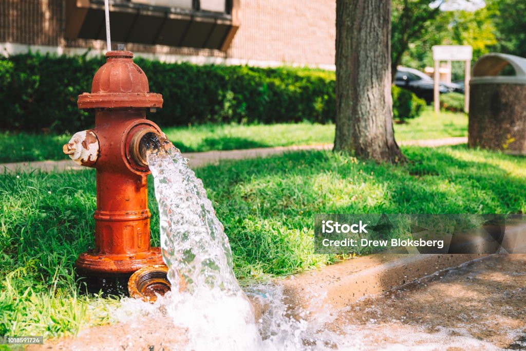 Open Fire Hydrant Open hydrant spewing water Fire Hydrant Stock Photo