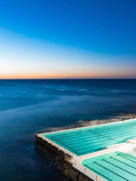 Bondi Icebergs Dawn Sydney, Australia - July 8, 2018: Dawn view at Bondi Icebergs pool towards the ocean. bondi beach sunrise stock pictures, royalty-free photos & images