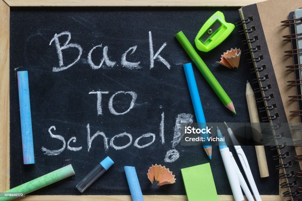 Freehand writing Back to school letters on chalkboard with School supplies Art Stock Photo