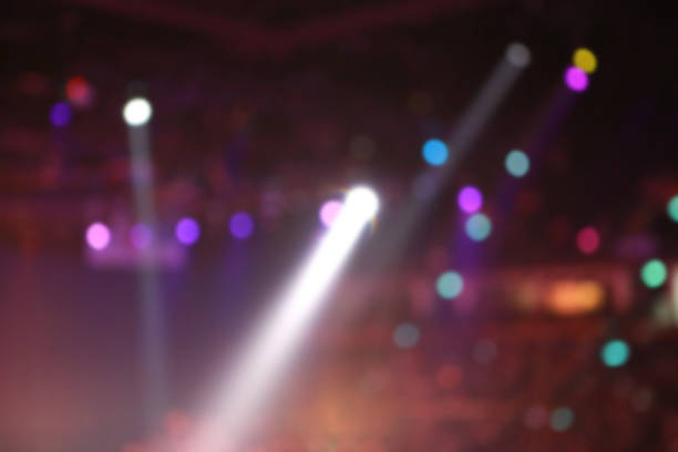 istock Blurred Concert light with colored spotlights and smoke. 1018618332