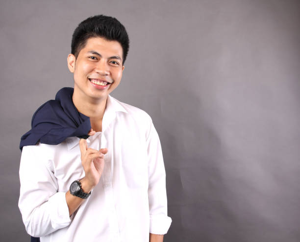 istock Asian guy smiles against white background. 1018618576