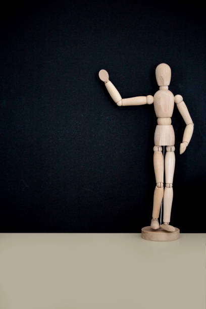 istock Mannequin pointing to blackboard with the text back to school 1018636502