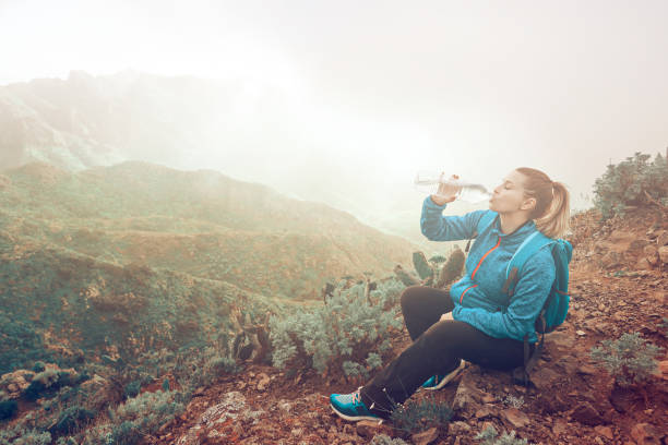 istock hiker woman drinking water 1018639720