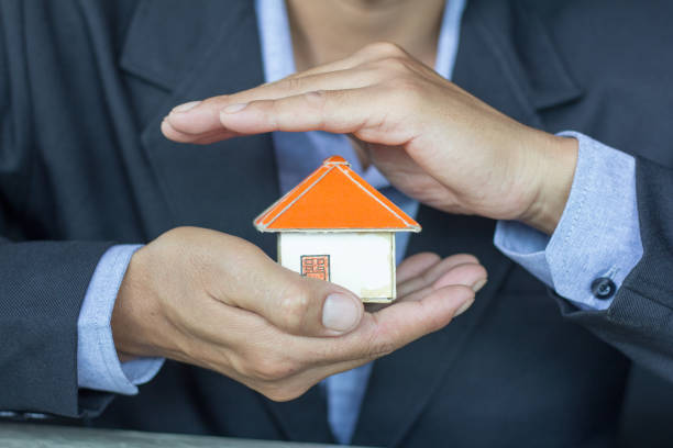 istock Young man use two hand to protect house model , concept home insurance. 1018643572