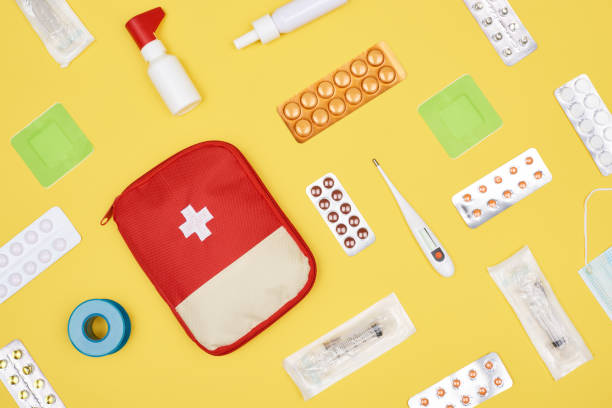 istock top view of first aid kit with various medicines isolated on yellow 1018644328