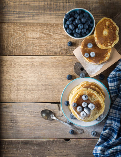Some pancakes with blueberry on the wood table