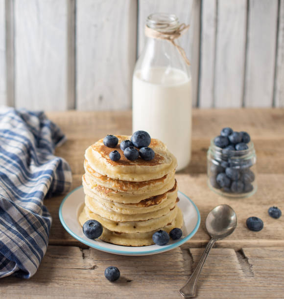 istock Some pancakes with blueberry and milk on the wood table 1018651778