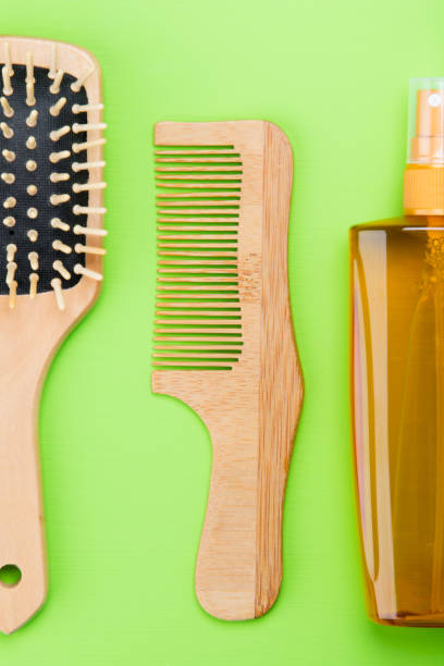 istock on a light green background. are items for hair, spray for combing, comb. 1018663440