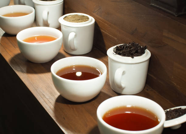 istock White tea pot and cups with the black tea leaves 1018676936