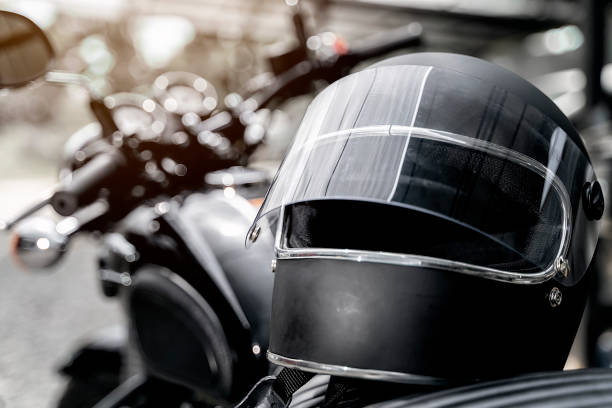 helmet on motorcycle seat Black helmet on motorcycle seat crash helmet stock pictures, royalty-free photos & images