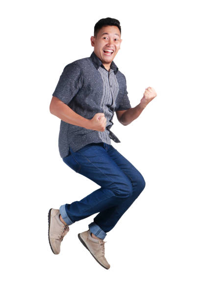 istock Happy Young Man Jumping and Shows Winning Gesture 1018688138