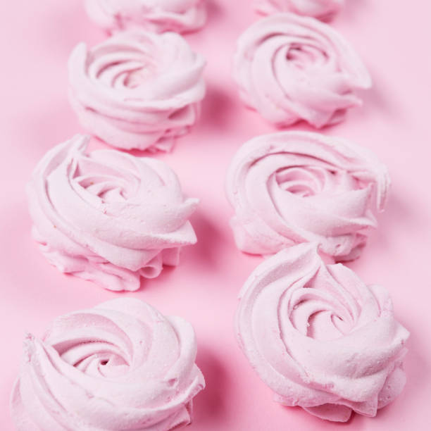 istock pink homemade apple marshmallow lying vertically in rows on a pink background, holiday concept, selective focusing 1018689062