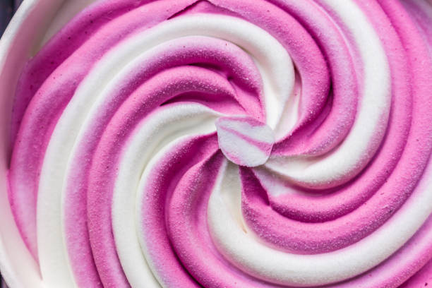 istock Swirling pink Italian ice cream with a ridged pattern background texture 1018703060