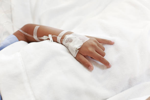 istock A child hand with Sodium Chloride Solution for Intravenous 1018703810