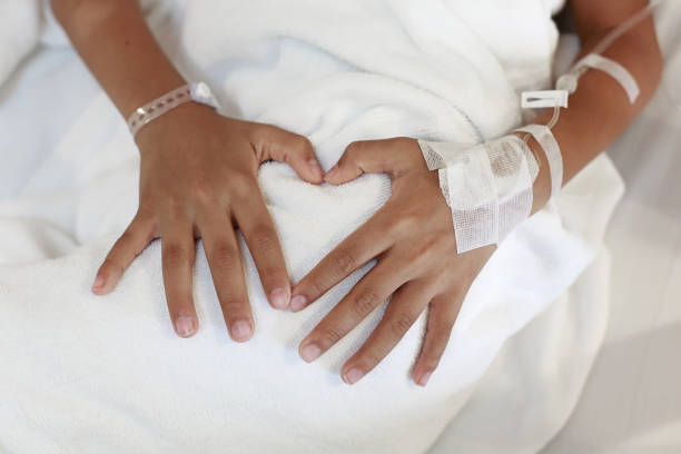 istock A child hand with Sodium Chloride Solution for Intravenous 1018703824