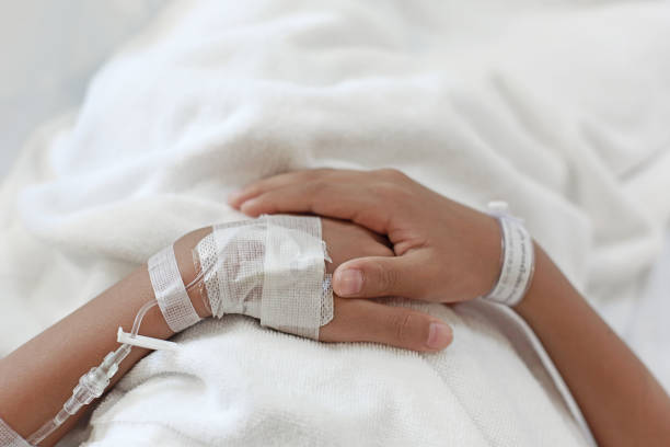 istock A child hand with Sodium Chloride Solution for Intravenous 1018703826