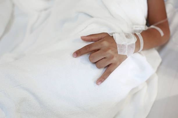 istock A child hand with Sodium Chloride Solution for Intravenous 1018703828