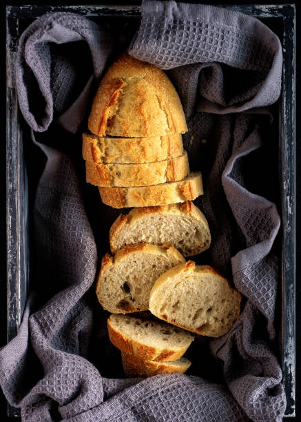 istock Sliced fresh bread in wooden box. Top view 1018703986