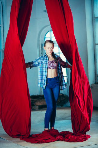 istock Graceful gymnast resting after performing aerial exercise at loft 1018710384