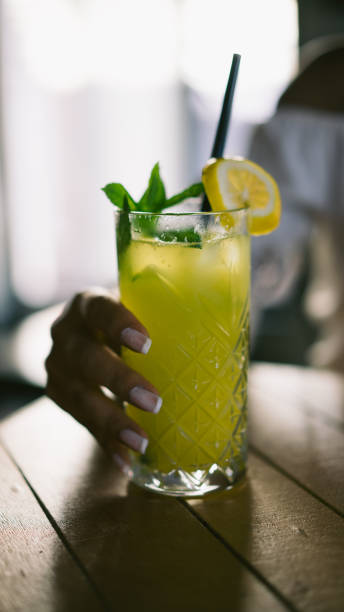 istock Beautiful woman drinking lemonade 1018710464
