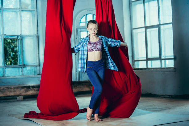 istock Graceful gymnast resting after performing aerial exercise at loft 1018710544