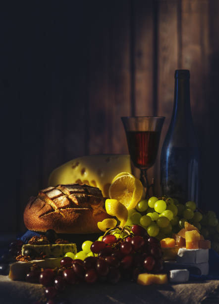 istock Still life with wine, grapes, bread and various sorts of cheese. 1018710878