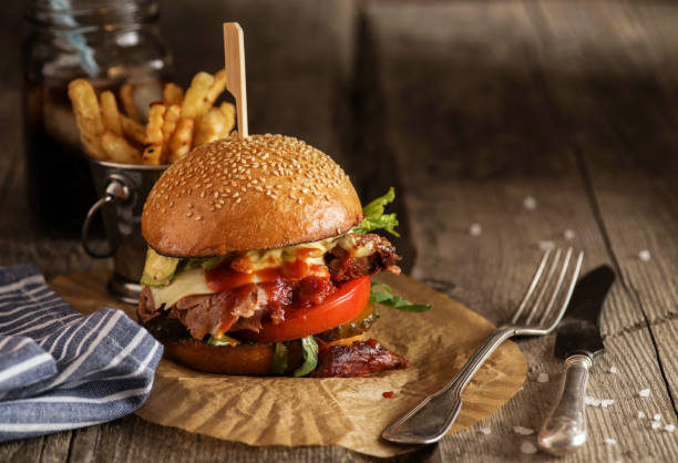istock Freshly cooked homemade burger with chopped beef, cheese and fresh herbs. 1018713404