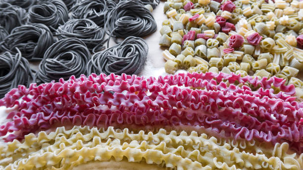 istock homemade raw italian multicolored pasta background 1018713476