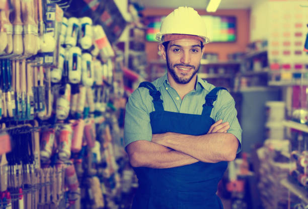 istock Man artisan with folded arms in paint store 1018715542